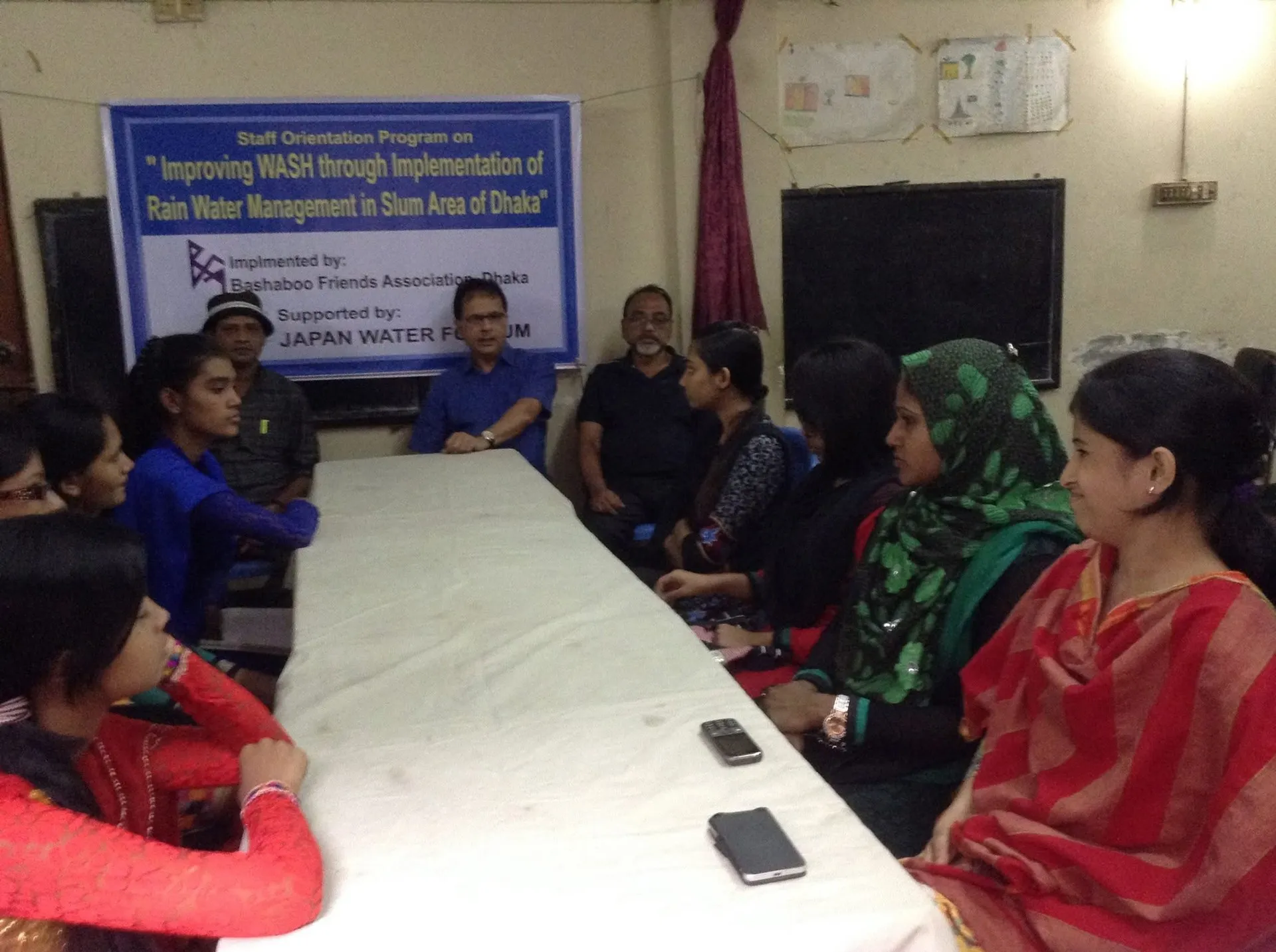 BFA staff and volunteers seated around a table at an orientation session